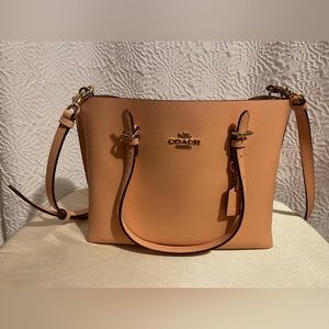 Pink coach purse with orange inside with attachable crossbody strap